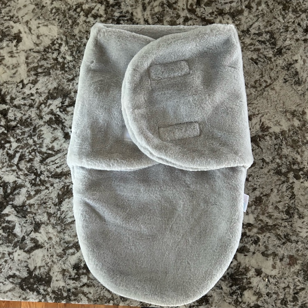 Light grey plush baby swaddle 👶🏼 1-3 months would fit best
